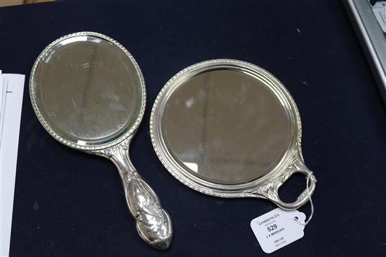 Two early 20th century repousse silver Reynolds Angels hand mirrors by William Comyns.